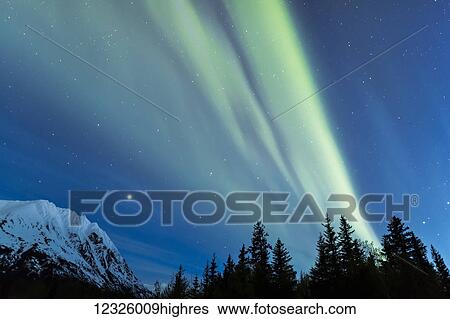 Stock Photograph - Faint green Aurora Borealis dances over the Kenai Mountains, Moose Pass, Kenai Peninsula, South-central Alaska; Alaska, United States of America. Fotosearch