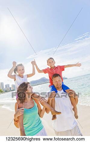 Family of four enjoying a summer holiday vacation in Hawaii on Waikiki Beach; Oahu, Hawaii, United States of America View Large Photo Image Stock Photograph - Family of four enjoying a summer holiday vacation in Hawaii on Waikiki Beach; Oahu, Hawaii, United States of America. Fotosearch