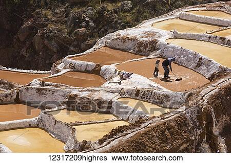 Stock Photograph - Family owned salt ponds in Sacred Valley near Urubama; Maras, Cusco, Peru. Fotosearch