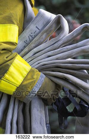 Fireman carrying empty hose View Large Photo Image Stock Image - Fireman carrying empty hose. Fotosearch