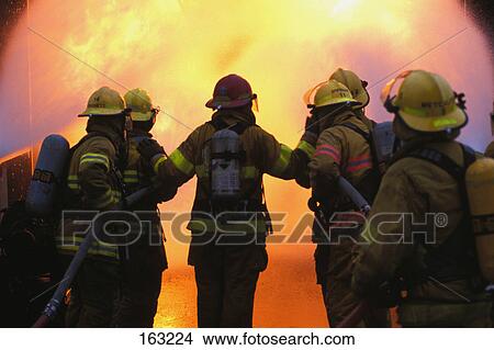 Picture - Firemen in front of fire. Fotosearch