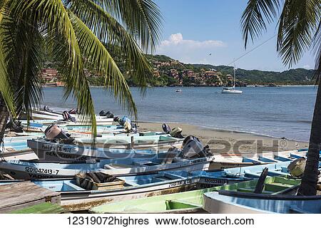 Stock Photograph - Fishing boats, also k0wn as Pangas, on Zihuatanjo beach; Zihuatanjo, Mexico. Fotosearch