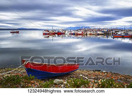 Stock Photograph - Fishing boats in a harbour, Chilean Patagonia; Puerto Natales, Ultima Esperanza, Chile. Fotosearch