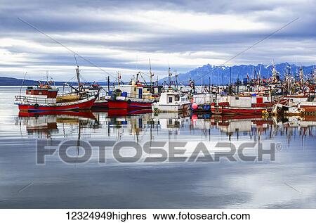 Stock Photograph - Fishing boats in a harbour, Chilean Patagonia; Puerto Natales, Ultima Esperanza, Chile. Fotosearch