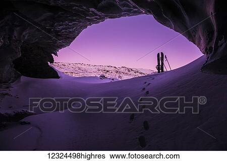 Footprints lead toward a splitboard placed at the entrance of an ice cave within Canwell Glacier in the Alaska Range after sunset in winter; Alaska, United States of America View Large Photo Image Stock Photograph - Footprints lead toward a splitboard placed at the entrance of an ice cave within Canwell Glacier in the Alaska Range after sunset in winter; Alaska, United States of America. Fotosearch