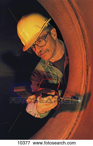 Stock Photo - Gas line inspector testing weld seams. Fotosearch