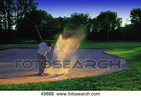 Golfer chipping out of sand trap View Large Photo Image Stock Photo - Golfer chipping out of sand trap. Fotosearch