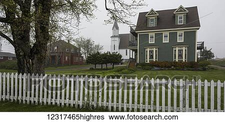 Green house, church and white pick fence, Cape Breton Island; Louisbourg, 0va Scotia, Canada View Large Photo Image Stock Photograph - Green house, church and white pick fence, Cape Breton Island; Louisbourg, 0va Scotia, Canada. Fotosearch