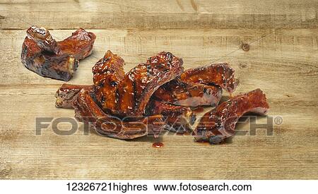 Hand cut ribs covered in sauce on a wooden counter View Large Photo Image Stock Photograph - Hand cut ribs covered in sauce on a wooden counter. Fotosearch