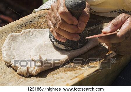 Stock Photograph - Hawaiian pounds taro into poi in Pu'u Honua O Honaunau National Park; Honaunau, Island of Hawaii, Hawaii, United States of America. Fotosearch