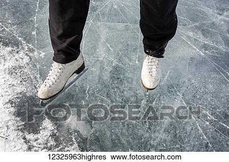 High angle view and close-up of white figure skates on ice; Calgary, Alberta, Canada View Large Photo Image Stock Photograph - High angle view and close-up of white figure skates on ice; Calgary, Alberta, Canada. Fotosearch