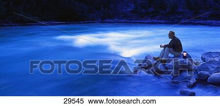 Hiker by river with lantern View Large Photo Image Stock Photography - Hiker by river with lantern. Fotosearch