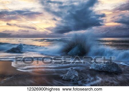 Stock Photograph - Ice chucks form the ice lagoon called Jokulsarlon along the south coast of Iceland. This beach is called the Diamond Beach because of all the ice deposited here; Iceland. Fotosearch