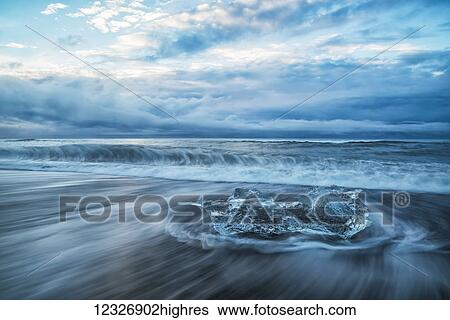 Stock Photograph - Ice chucks form the ice lagoon called Jokulsarlon along the south coast of Iceland. This beach is called the Diamond Beach because of all the ice deposited here; Iceland. Fotosearch