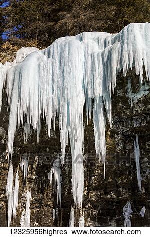 Stock Photograph - Ice formations hanging on rock cliff in Johnson Canyon; Alberta, Canada. Fotosearch