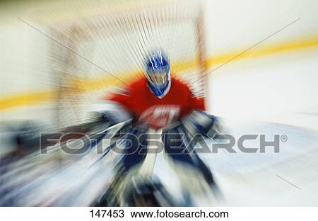 Stock Image - Ice hockey goalie making save. Fotosearch