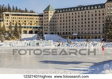 Ice Skaters on the outdoor skating rink during the daytime on the frozen Lake in Banff National Park, with the Fairmont Chateau Lake Louise in the background; Lake Louise, Alberta, Canada View Large Photo Image Stock Photograph - Ice Skaters on the outdoor skating rink during the daytime on the frozen Lake in Banff National Park, with the Fairmont Chateau Lake Louise in the background; Lake Louise, Alberta, Canada. Fotosearch