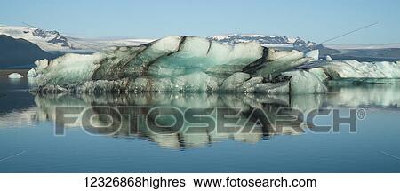 Iceberg floating in Jokulsarlon, a glacial lagoon along the South coast of Iceland; Iceland View Large Photo Image Stock Photograph - Iceberg floating in Jokulsarlon, a glacial lagoon along the South coast of Iceland; Iceland. Fotosearch