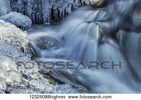 Icicles and blue shadowed cascades on a small waterfall; Enfield, Nova Scotia, Canada View Large Photo Image Stock Photograph - Icicles and blue shadowed cascades on a small waterfall; Enfield, Nova Scotia, Canada. Fotosearch