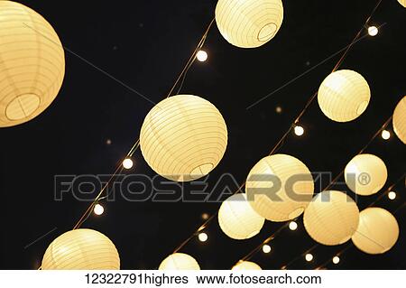 Illuminated round lanterns strung in rows View Large Photo Image Stock Photograph - Illuminated round lanterns strung in rows. Fotosearch