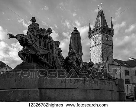 Jan Hus memorial and a clock tower in Old Town Square; Prague, Czech Republic View Large Photo Image Stock Photograph - Jan Hus memorial and a clock tower in Old Town Square; Prague, Czech Republic. Fotosearch