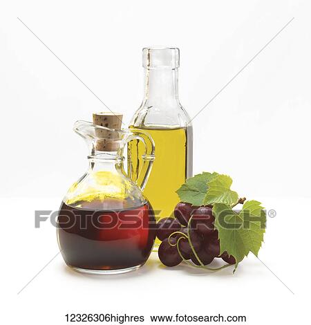 Jars of oil and vinegar and a cluster of grapes on a white background View Large Photo Image Stock Photograph - Jars of oil and vinegar and a cluster of grapes on a white background. Fotosearch