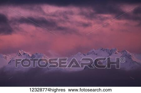 Stock Photograph - Kachemak Bay State Park at sunset with glowing pink sky; Alaska, United States of America. Fotosearch