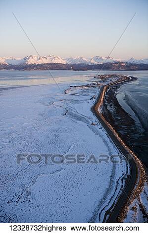 Landscape in winter, with a mountain range in the distance; Alaska, United States of America View Large Photo Image Stock Photograph - Landscape in winter, with a mountain range in the distance; Alaska, United States of America. Fotosearch
