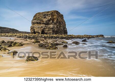 Stock Photograph - Large sea stack on sandy beach on the North East coast of England; South Shields, Tyne and Wear, England. Fotosearch