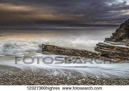 Stock Photograph - Late afternoon winter seascape in North East England; South Tyneside, Tyne and Wear, England. Fotosearch
