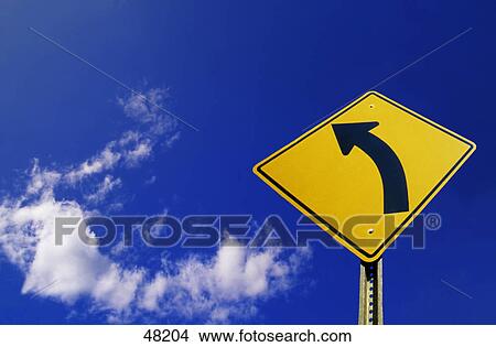 Picture - Left turn sign against sky. Fotosearch