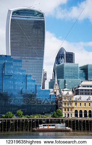Stock Photograph - Looking across the River Thames to the City of London (The Walkie Talkie building and The Gherkin, centre); London, England. Fotosearch