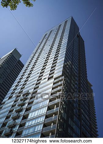 Stock Photograph - Low angle view of a residential skyscraper against a blue sky; Toronto, Ontario, Canada. Fotosearch