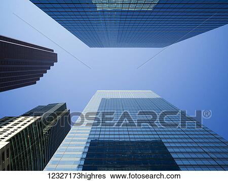 Low angle view of the tops of skyscrapers in a blue sky; Toronto, Ontario, Canada View Large Photo Image Stock Photograph - Low angle view of the tops of skyscrapers in a blue sky; Toronto, Ontario, Canada. Fotosearch