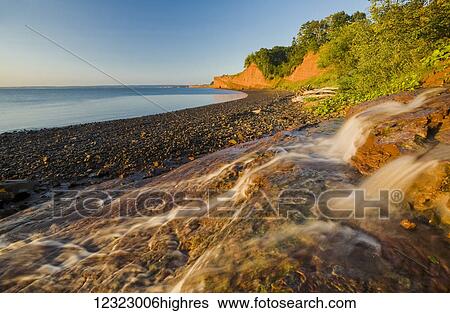Low tide and sandstone cliffs, Cape Blomidon Provincial Park in the Minas Basin, Bay of Fundy; Nova Scotia, Canada View Large Photo Image Stock Photograph - Low tide and sandstone cliffs, Cape Blomidon Provincial Park in the Minas Basin, Bay of Fundy; Nova Scotia, Canada. Fotosearch