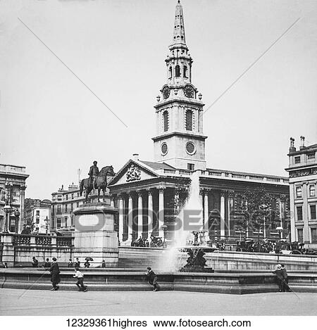 Stock Photograph - Magic lantern slide circa 1900. Victorian. Fountain in Trafalgar Square showing equestrian statue of Charles I and St Martin-in-the-Fields, London, England, United Kingdom. Children playign around fountain.. Fotosearch