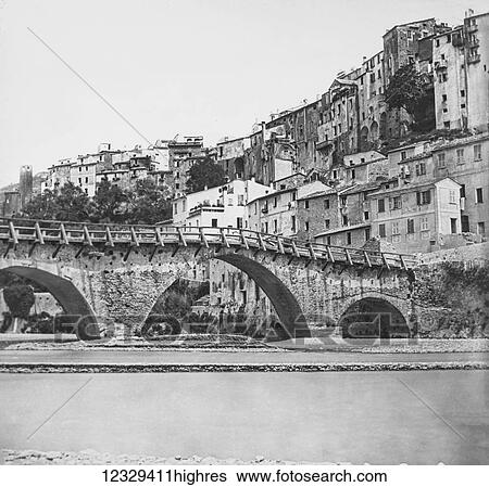 Stock Photograph - Magic lantern slide circa 1900. Victorian, A stone arched bridge with wooden handrails surrounded by very old buildings possible Rome. Fotosearch