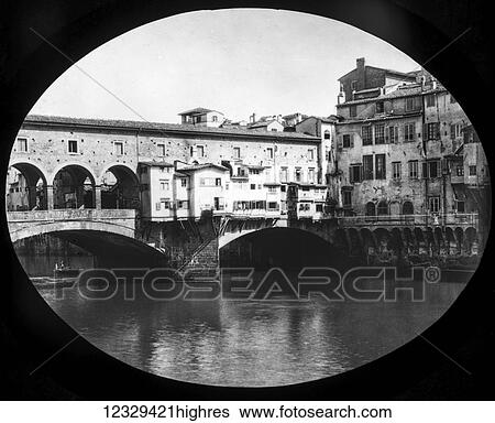 Stock Photograph - Magic lantern slide circa 1900. Victorian. Pont Vecchio bridge. The Ponte Vecchio is a medieval stone closed-spandrel segmental arch bridge over the Arno River, in Florence, Italy, noted for still having shops built along it, as was once common. Butchers.... Fotosearch