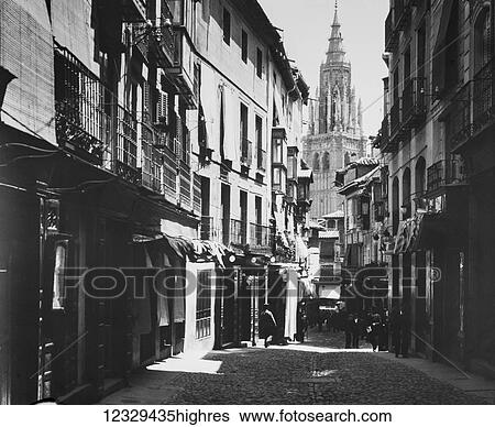 Stock Photograph - Magic lantern slide circa 1900. Victorian. Photograph Spanish street with cathedral at end of lane. Photographed by Dr Feilchenfield. Fotosearch