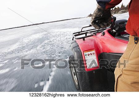 Stock Photograph - Man on a freshwater harbor seal hunt in winter, Lake Iliamna, Pedro Bay, Southcentral Alaska, USA. Fotosearch