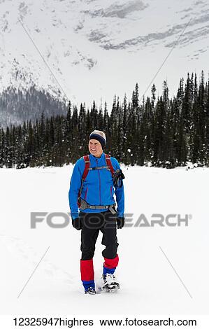 Man snowshoeing in the mountains, East of Field; British Columbia, Canada View Large Photo Image Stock Photograph - Man snowshoeing in the mountains, East of Field; British Columbia, Canada. Fotosearch