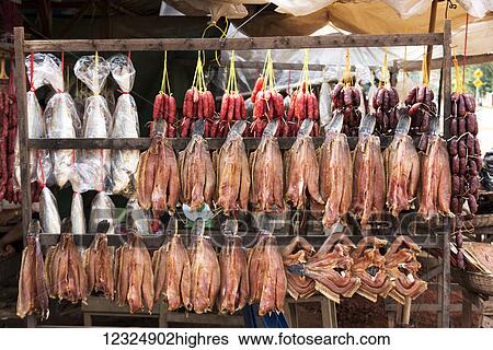 Stock Photograph - Meat hanging on display for retail; Siem Reap Province, Cambodia. Fotosearch