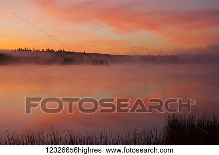 Stock Photograph - Misty autumn morning at Millers Lake; Nova Scotia, Canada. Fotosearch