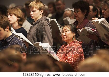 Stock Photograph - Mixed ethnicities sing at a choir concert, Alaska, USA. Fotosearch