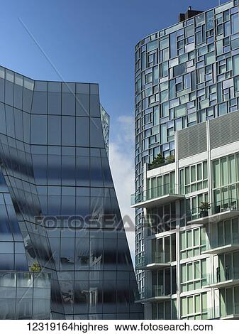 Modern residential buildings with window facades against a blue sky; New York City, New York, United States of America View Large Photo Image Stock Photograph - Modern residential buildings with window facades against a blue sky; New York City, New York, United States of America. Fotosearch