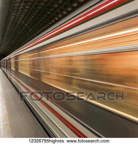 Stock Photograph - Motion blur of the side of a train passing through a station; Prague, Czech Republic. Fotosearch