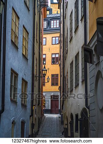 Stock Photograph - Narrow street between residential buildings; Stockholm, Sweden. Fotosearch