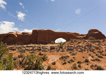 Natural arch in the rugged rock formation in the desert, Arches National Park; Utah, United States of America View Large Photo Image Stock Photograph - Natural arch in the rugged rock formation in the desert, Arches National Park; Utah, United States of America. Fotosearch