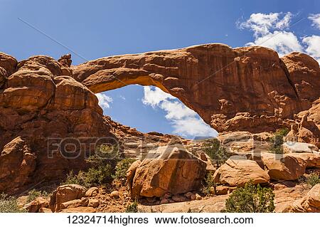 Stock Photograph - Natural arch in the rugged rock formation in the desert, Arches National Park; Utah, United States of America. Fotosearch