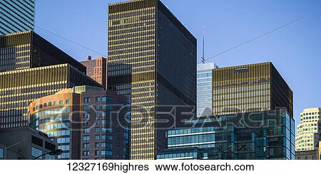 Numerous skyscrapers with different facades against a blue sky; Toronto, Ontario, Canada View Large Photo Image Stock Photograph - Numerous skyscrapers with different facades against a blue sky; Toronto, Ontario, Canada. Fotosearch